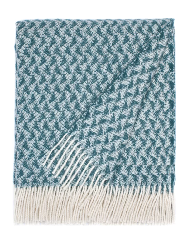 A wool blanket featuring a detailed geometric pattern in beige and white, complete with white fringe edges, made by weaving mill Barker Textiles.