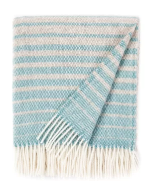 A wool blanket with a striped pattern in shades of light blue and cream, featuring white fringes, made by weaving mill Barker Textiles.