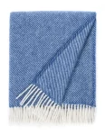 A wool blanket with a subtle diagonal stripe pattern in blue and white, featuring white fringes, made by weaving mill Barker Textiles.