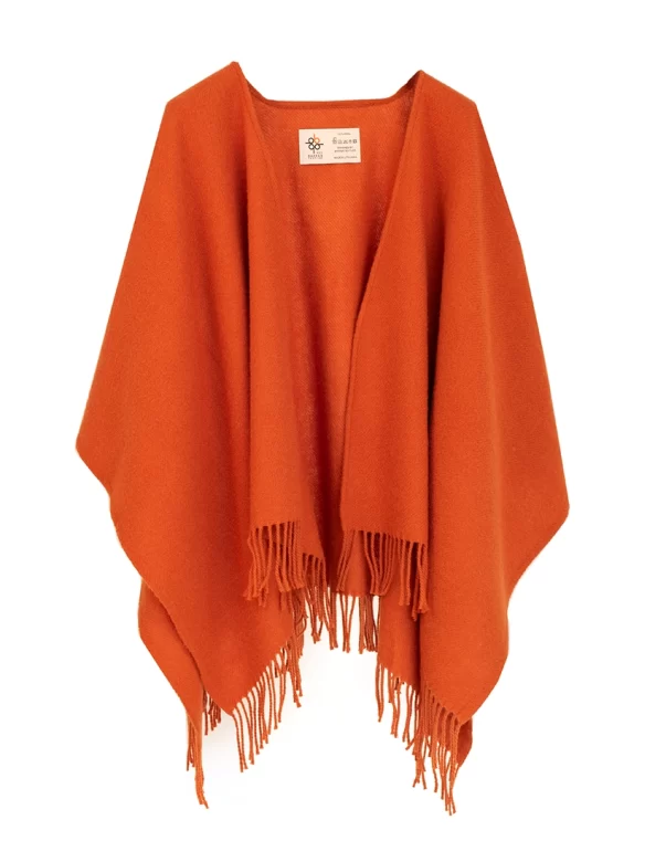 Orange wool cape with white fringes at the bottom made by weaving mill Barker Textiles.