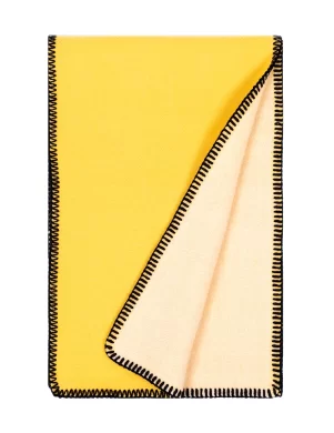 Yellow and white blanket with black stitching on the edges made by weaving mill Barker Textiles.