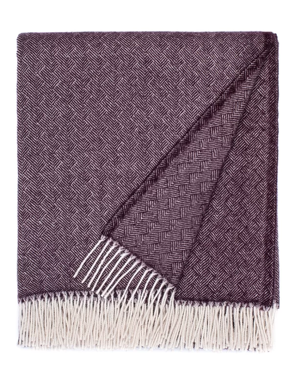 Purple wool blanket with a herringbone pattern, finished with white fringes, made by weaving mill Barker Textiles.