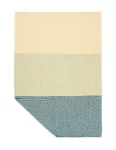 A baby blanket with a simple, geometric design, featuring broad stripes in cream, sage green, and teal, with a folded corner revealing the reverse side of the pattern made by weaving mill Barker Textiles.