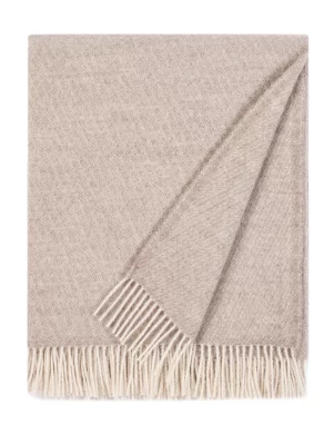 Beige wool blanket with subtle pattern and white fringes, produced by weaving mill Barker Textiles.