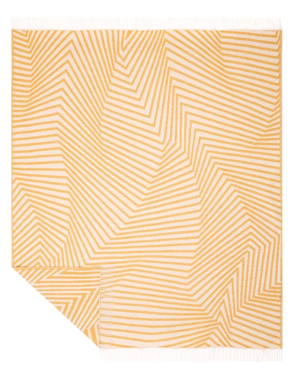 A yellow and white wool blanket with a zigzag stripe pattern and fringed edges, made by Barker Textiles.