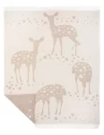 Beige wool blanket featuring a pattern of deer, designed by weaving mill Barker Textiles.