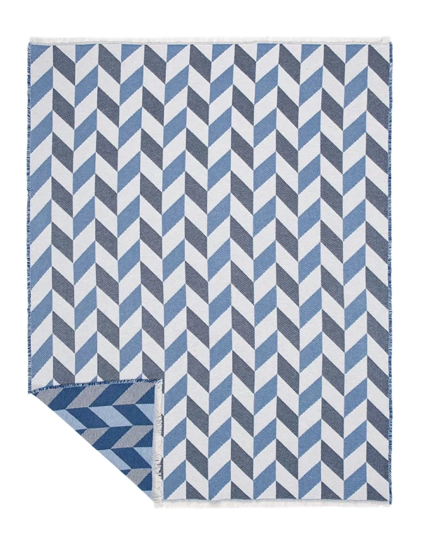 A jacquard cotton blanket featuring a unique leaf pattern in soft, neutral tones, made by weaving mill Barker Textiles.