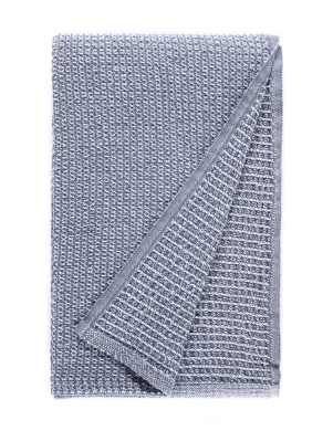 A blanket with a simple, small-scale waffle weave pattern in gray. The texture is subtle and the design is minimalistic, providing a classic look, made by weaving mill Barker Textiles.