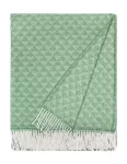 A green wool blanket with a diamond pattern and white fringes, made by Barker Textiles.